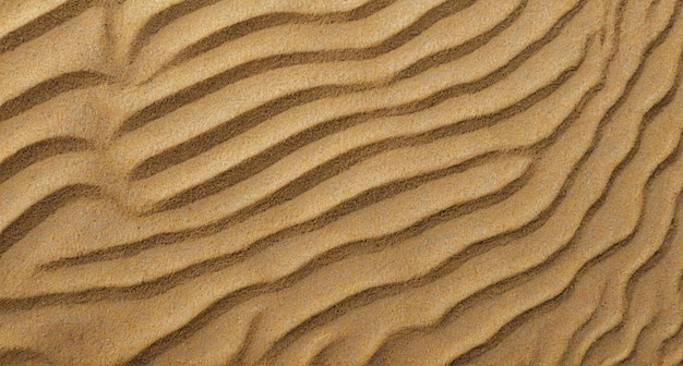 Photo the texture of the brown sand is from a natural pattern