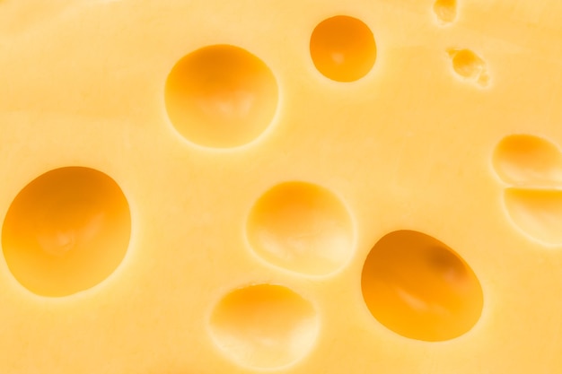 Texture of the cheese. Pattern of cheese with large holes.