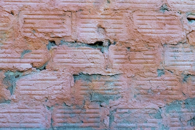 Texture of a concrete wall with traces of dismantled facing tiles