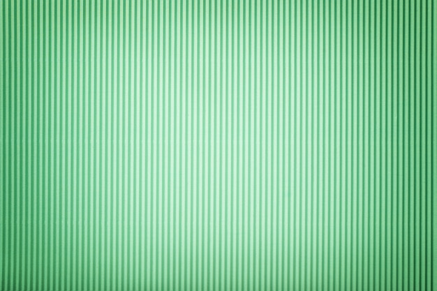 Texture of corrugated green paper with vignette, macro.