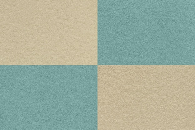 Texture of craft beige and blue paper background with cells pattern macro Vintage kraft cerulean cardboard