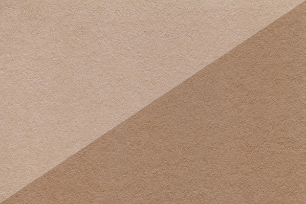 Texture of craft beige and brown paper background half two colors macro Structure of vintage dense kraft cardboard