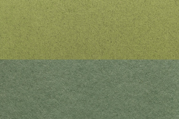 Texture of craft dark green and olive paper background half two colors macro Structure of vintage khaki cardboard