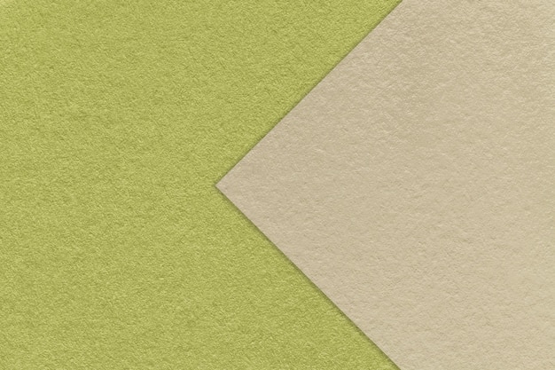 Texture of craft green paper background half two colors with beige arrow macro Kraft olive cardboard