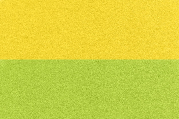 Texture of craft green and yellow paper background half two colors macro Vintage dense olive cardboard