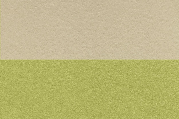 Texture of craft light beige and green paper background half two colors macro Vintage kraft olive cardboard