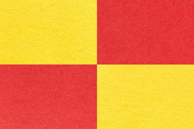 Texture of craft red and yellow paper background with cells pattern macro Vintage kraft cardboard