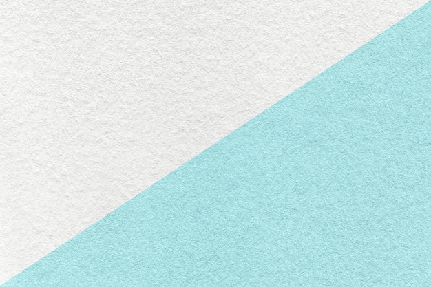 Texture of craft white and light blue paper background half two colors macro Structure of turquoise kraft cardboard