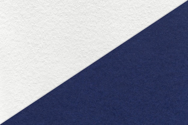 Texture of craft white and navy blue paper background half two colors Structure of vintage kraft denim cardboard