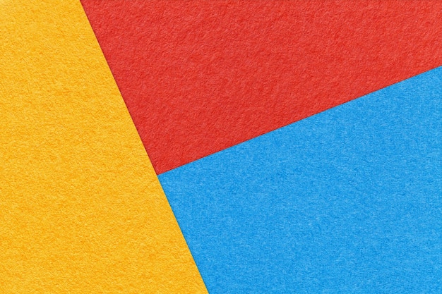 Texture of craft yellow blue and bright red shade color paper background macro Abstract cardboard