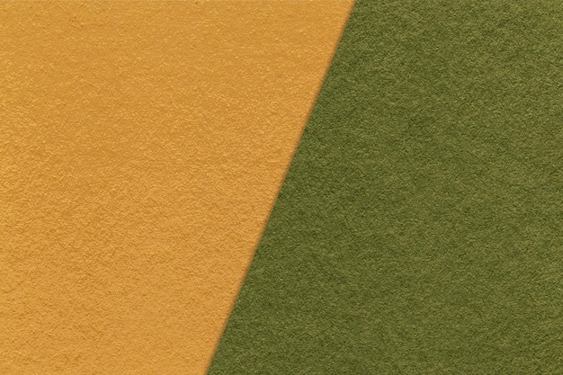 Texture of craft yellow and dark green paper background half two colors macro Vintage kraft olive cardboard