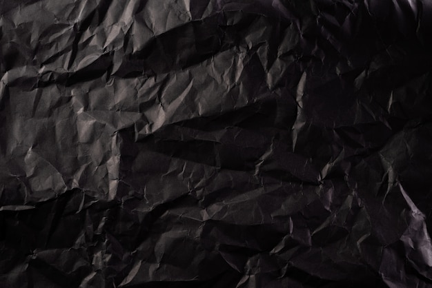 Texture of crumpled black paper. Creative vintage background.