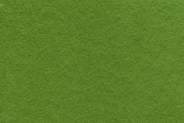 Texture of dark green and olive colors paper background macro Structure of dense lime craft cardboard