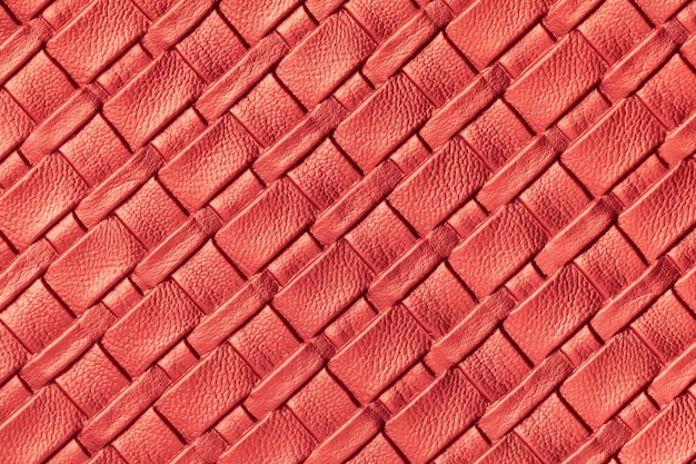 Texture of dark red leather with wicker pattern, macro.