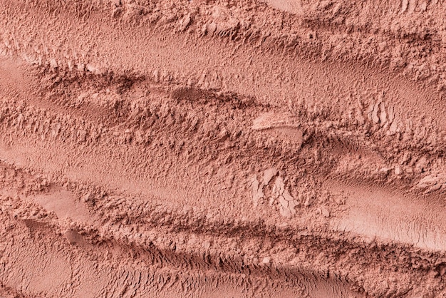 Texture of dry red cosmetic clay with brushstroke Background of pink cosmetic clay or eye shadow