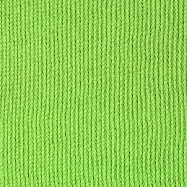 The texture of the fabric is bright green. Material for making shirts and blouses