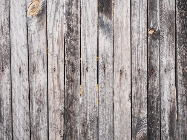 The texture of the fence of the old gray boards at sunset