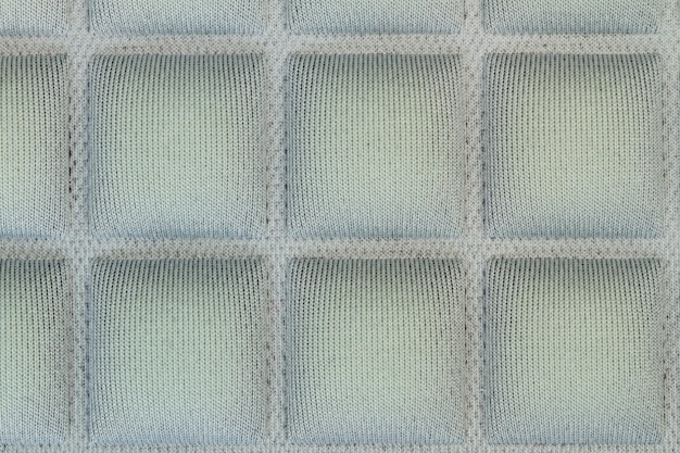 Texture of a green cloth with squares in a close up view