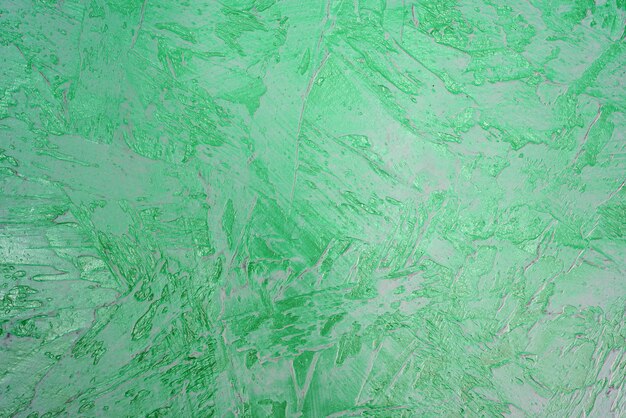 Texture of green plaster. Rough wall of the building.