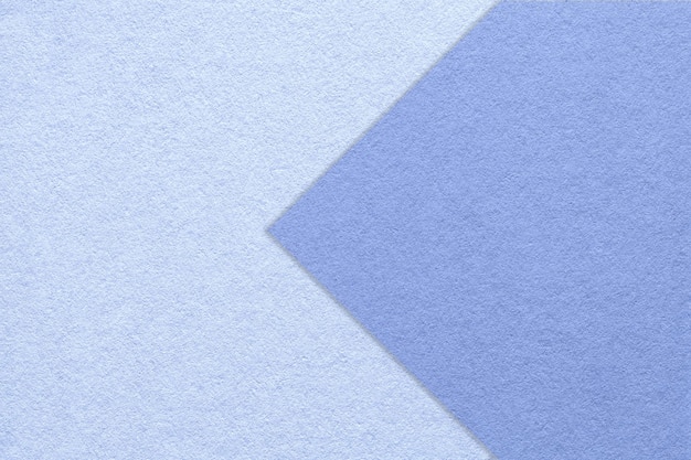 Texture of light blue paper background half two colors with very peri arrow macro Craft sky cardboard