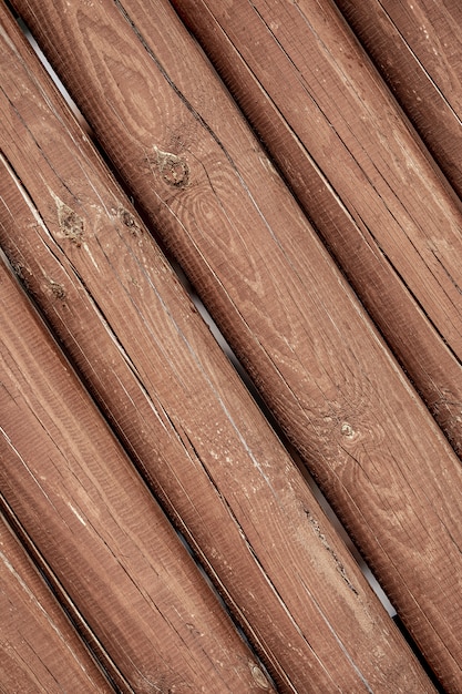 The texture of the logs. Wall of a rural house made of wooden logs with knots. Wooden background, copy space.