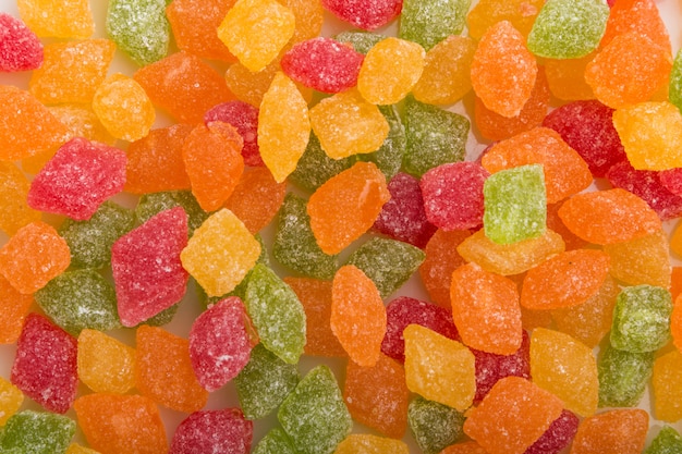 Texture of multicolored candies on white 