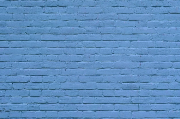 Texture of old blue brick wall surface with cement and concrete seams