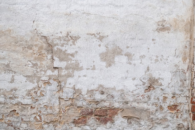 Texture of old cracked, rustic plastered brick wall