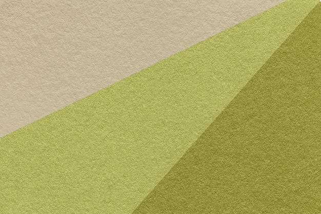 Texture of old craft beige and green color paper background macro Vintage abstract olive cardboard