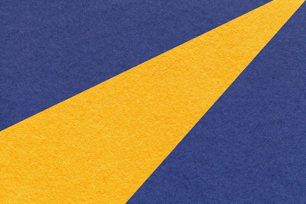 Texture of old craft navy blue and yellow color paper background macro Vintage abstract denim cardboard