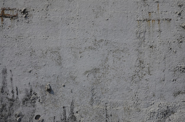 Texture of the old embossed concrete wall in gray color. Background image of a concrete product