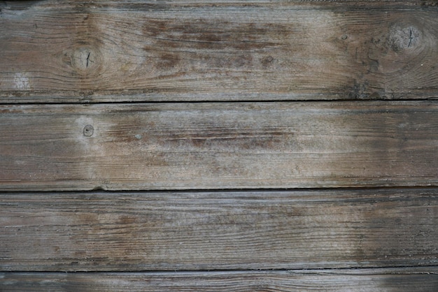 Texture of an old fence made of wooden boards closeup