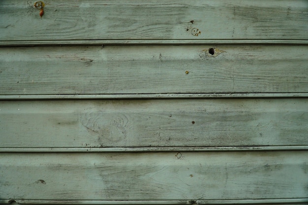 Texture of an old fence made of wooden boards closeup