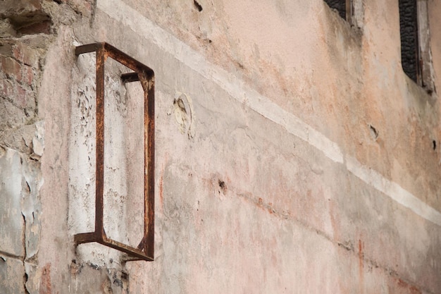 Texture of an old ragged wall background of old bricks and cracks in plaster yellow and brown tones