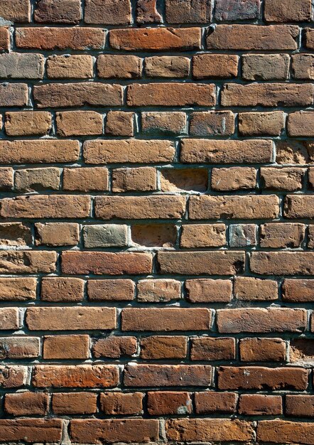 Texture of old red brick wall with shadows