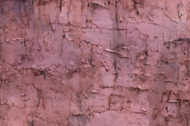 Texture of old rustic wall covered with pink stucco Abstract background for design