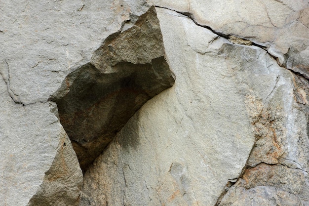 Texture of old stone rock weathered surface Nature detail of rocks Closeup rough brown stone wall