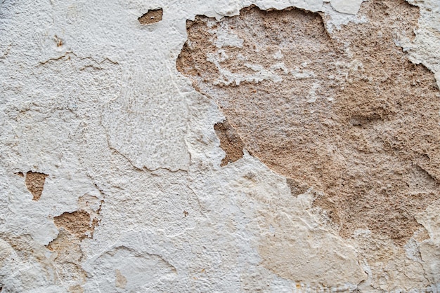 Texture of an old wall with peeling plaster