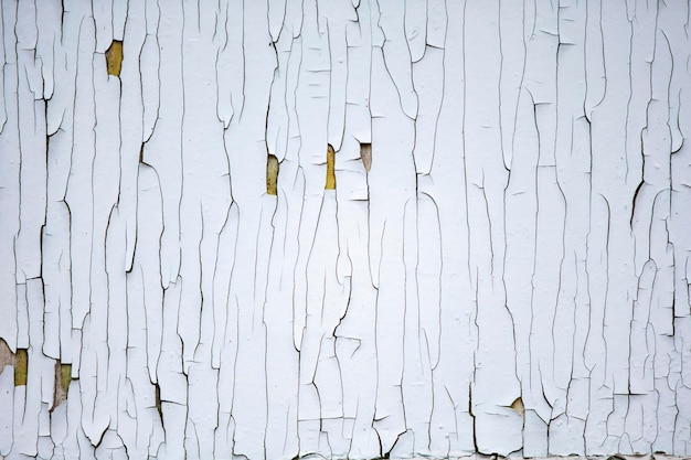 Texture of an old wall with peeling white paint