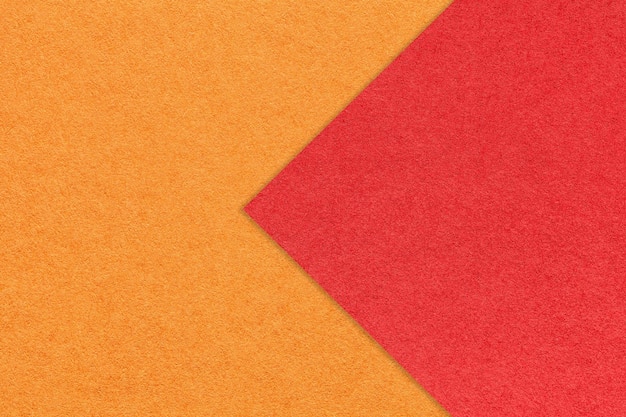 Texture of orange paper background half two colors with red arrow macro Structure of craft ginger cardboard