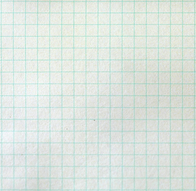 The texture of the paper background. Blank sheets of square and lined paper from a block on a gray background