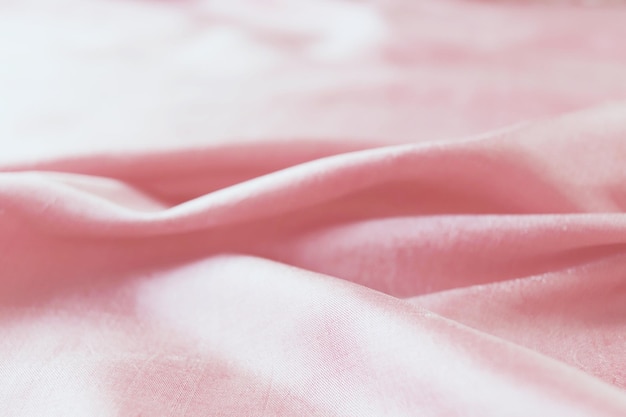 Texture of pink natural silk, folds, top view