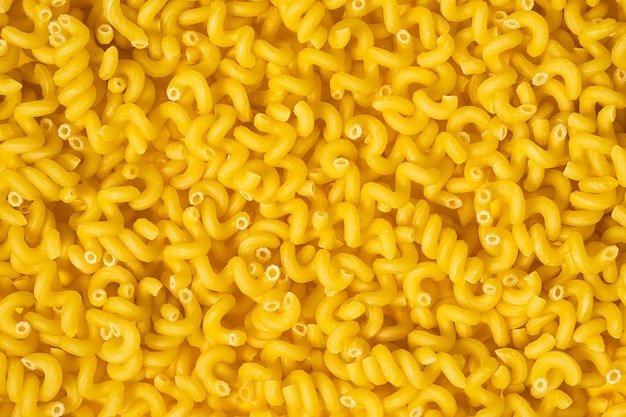 Texture of raw Cavatappi Cellentani noodles pasta italian food macro background