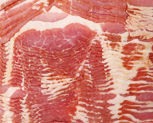 Texture of sliced raw bacon, full frame, close up