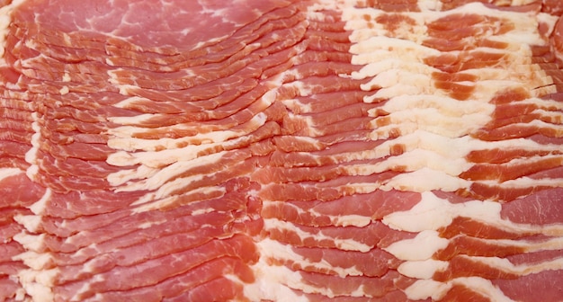 Texture of sliced raw bacon, full frame, close up