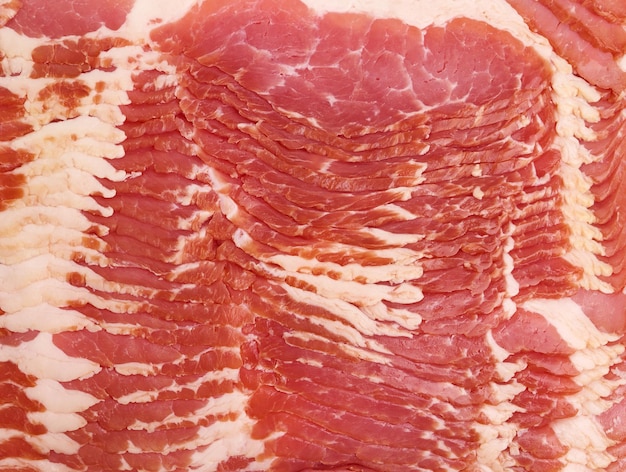 Texture of sliced raw bacon full frame close up