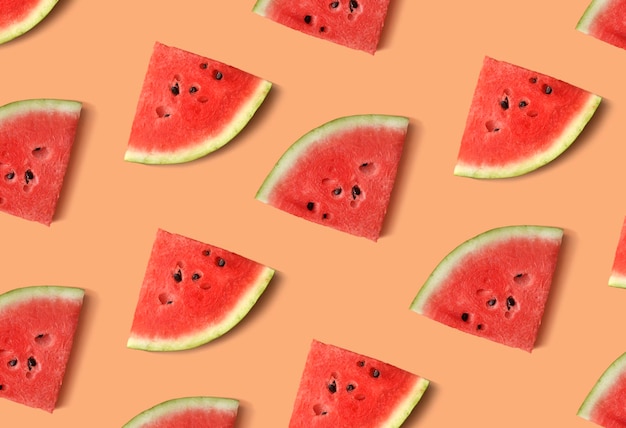 Texture of slices of red watermelon on an orange background