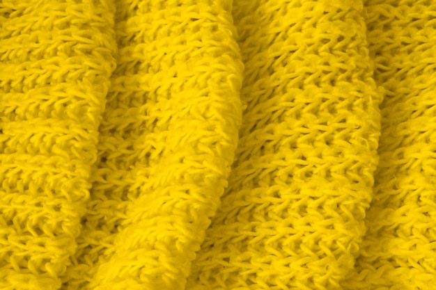 Texture of soft yellow knitted fabric as background. Banner for design