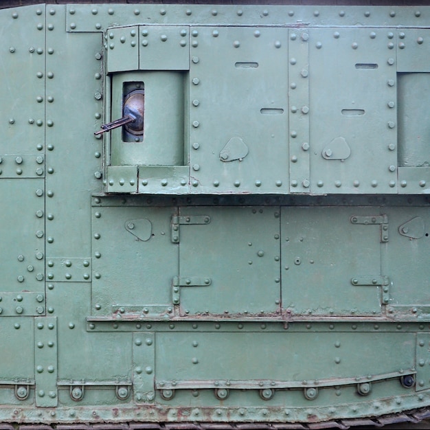 Texture of tank side wall, made of metal and reinforced with a multitude of bolts and rivets