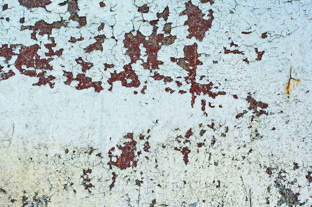 Texture of vintage rusty gray iron wall background with many layers of paint and rust